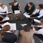 Overhead View Of Businesspeople Seated In Circle At Company Seminar